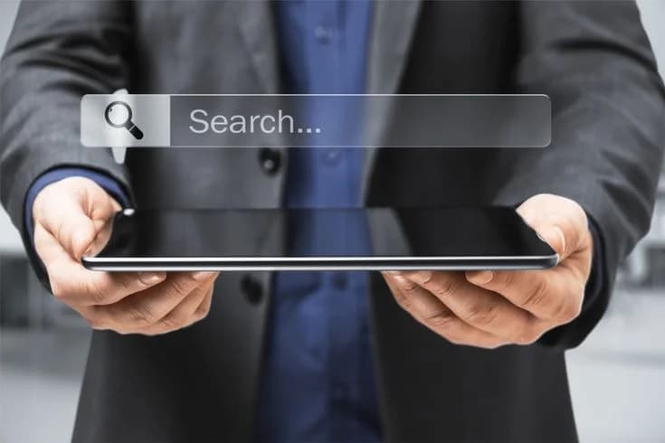 Bridging search intent and live transfers to lower cost-per-acquisition — businessman searching on tablet
